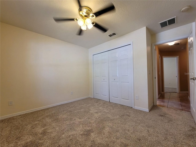 1914 Commander Way, Kissimmee, FL 34746 - unfurnished bedroom featuring carpet, a closet, a ceiling fan, and a textured ceiling