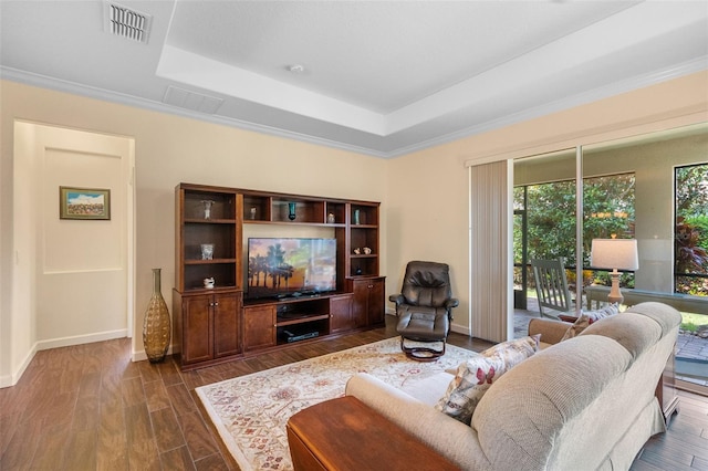 3685 Corsica Ln, Clermont, FL 34711 - living room featuring a tray ceiling, dark wood-type flooring, and crown molding