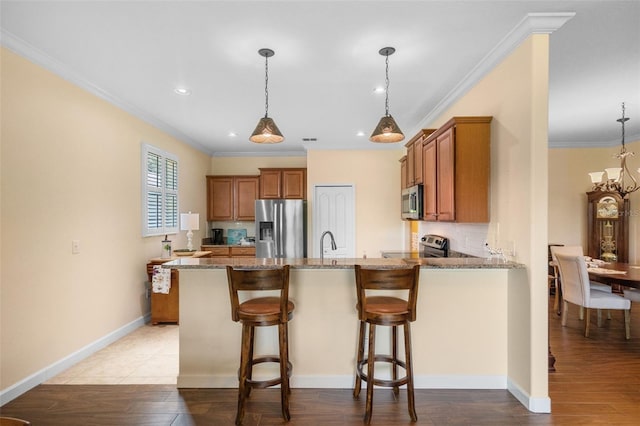3685 Corsica Ln, Clermont, FL 34711 - kitchen featuring brown cabinets, stone counters, a peninsula, ornamental molding, and light wood-style flooring