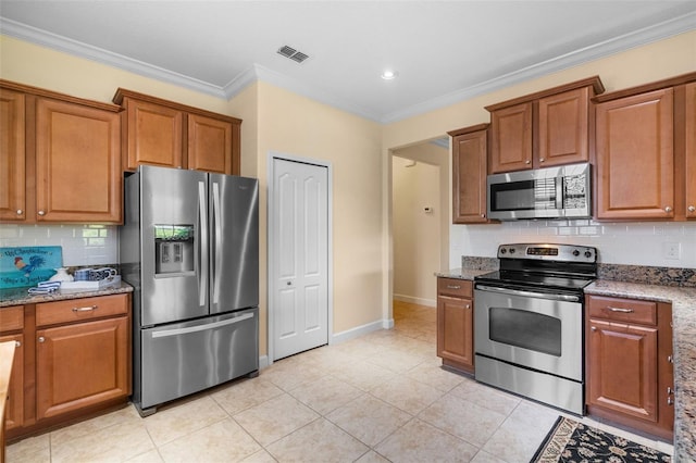 3685 Corsica Ln, Clermont, FL 34711 - kitchen with stainless steel appliances, brown cabinetry, light stone counters, crown molding, and recessed lighting