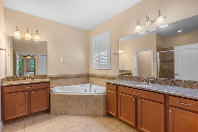 3685 Corsica Ln, Clermont, FL 34711 - full bathroom with tile patterned floors, a shower stall, two vanities, and a garden tub