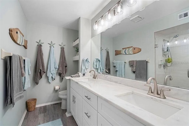 431 Cerromar Ln Unit 446, Venice, FL 34293 - bathroom with double vanity, wood finished floors, and a stall shower