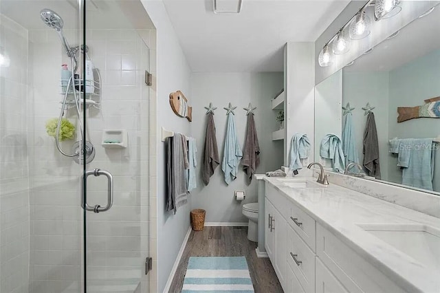 431 Cerromar Ln Unit 446, Venice, FL 34293 - bathroom with wood finished floors, double vanity, and a stall shower
