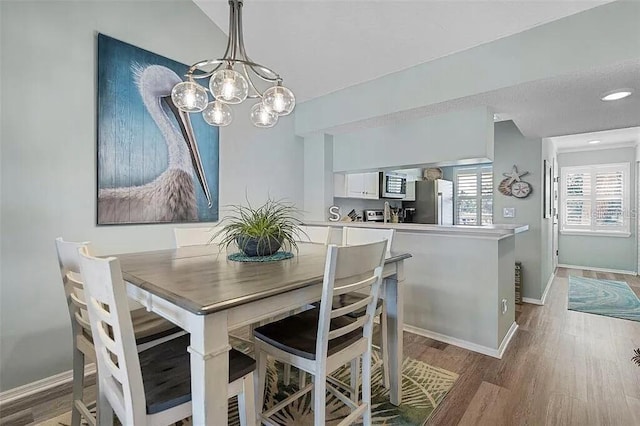 431 Cerromar Ln Unit 446, Venice, FL 34293 - dining room featuring wood finished floors and a chandelier
