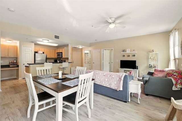 2025 Erving Cir Unit 203, Ocoee, FL 34761 - dining area featuring ceiling fan and light wood-style flooring