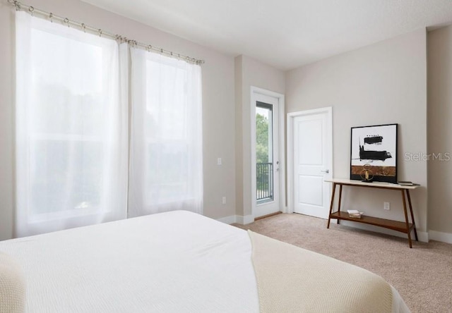 2105 Broome St, Kissimmee, FL 34743 - bedroom with access to exterior and light colored carpet