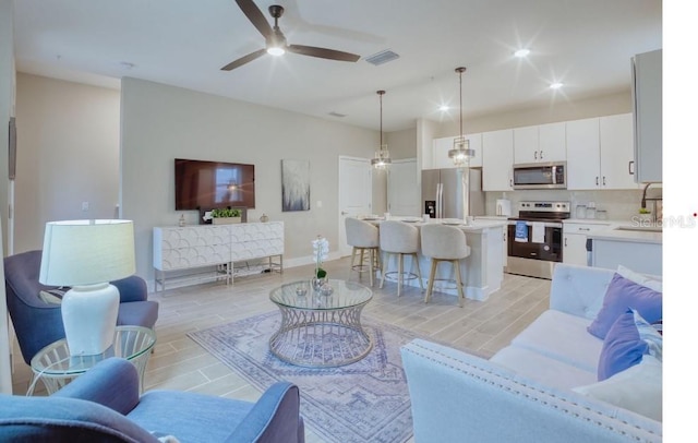2113 Broome St, Kissimmee, FL 34743 - living room with a ceiling fan and wood tiled floors