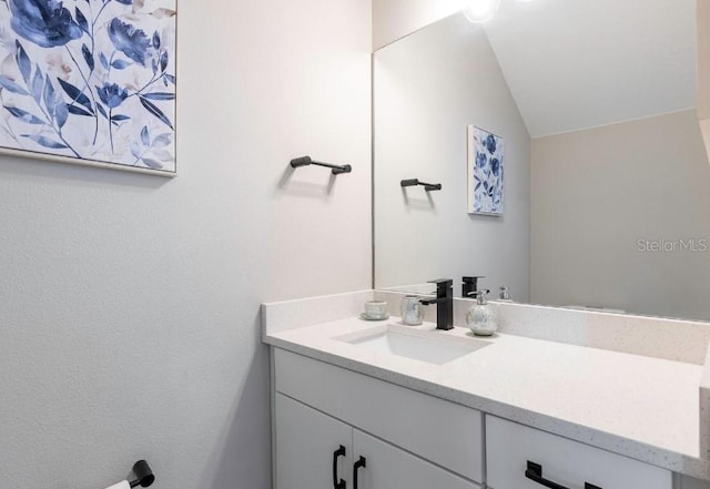 2113 Broome St, Kissimmee, FL 34743 - bathroom with vanity and lofted ceiling