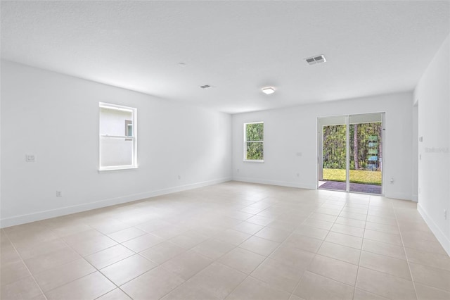 1261 Champions Dr, Daytona Beach, FL 32124 - spare room featuring light tile patterned floors and baseboards