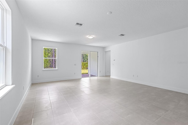 1261 Champions Dr, Daytona Beach, FL 32124 - unfurnished room with light tile patterned floors and a textured ceiling