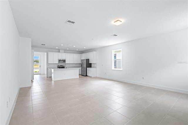 1261 Champions Dr, Daytona Beach, FL 32124 - unfurnished living room featuring recessed lighting and light tile patterned flooring