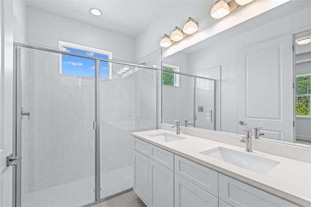 1261 Champions Dr, Daytona Beach, FL 32124 - bathroom featuring double vanity, a stall shower, and recessed lighting