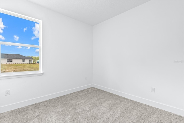 1261 Champions Dr, Daytona Beach, FL 32124 - spare room with carpet and baseboards