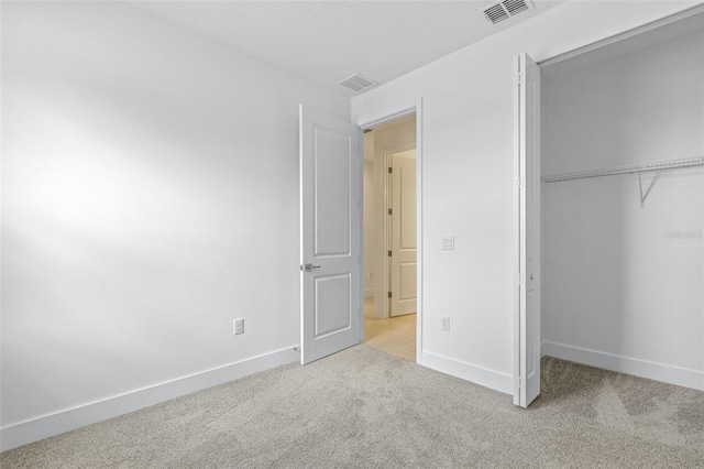 1261 Champions Dr, Daytona Beach, FL 32124 - unfurnished bedroom with light carpet and a closet