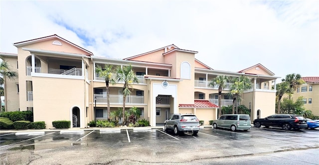 445 Bouchelle Dr Unit 104, New Smyrna Beach, FL 32169 - view of apartment building / complex with uncovered parking