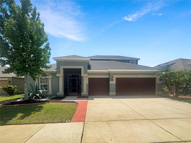 12671 Flatwood Creek Dr, Gibsonton, FL 33534 - prairie-style home with an attached garage, stucco siding, driveway, and a front lawn