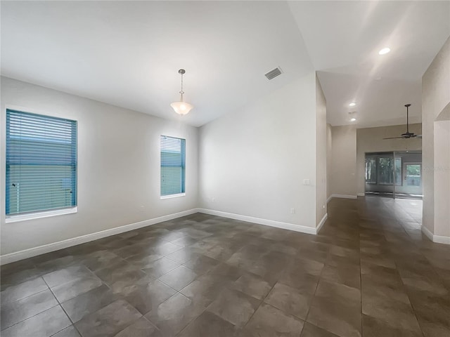12671 Flatwood Creek Dr, Gibsonton, FL 33534 - empty room featuring a ceiling fan, vaulted ceiling, dark tile patterned floors, and recessed lighting