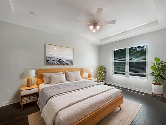 12671 Flatwood Creek Dr, Gibsonton, FL 33534 - bedroom with a tray ceiling, wood-type flooring, and a ceiling fan