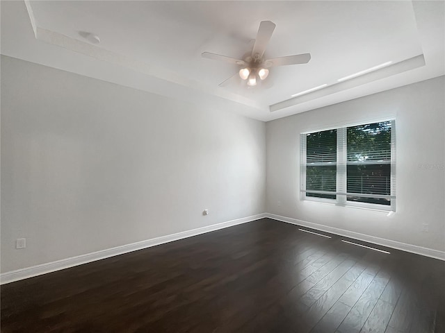 12671 Flatwood Creek Dr, Gibsonton, FL 33534 - spare room featuring a raised ceiling, dark wood finished floors, and a ceiling fan