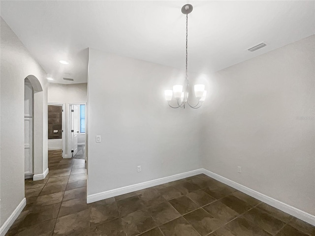 12671 Flatwood Creek Dr, Gibsonton, FL 33534 - unfurnished dining area with arched walkways, a chandelier, and dark tile patterned floors