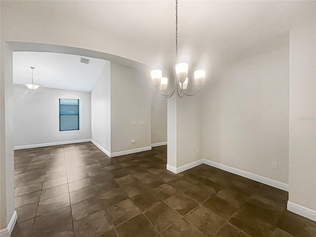 12671 Flatwood Creek Dr, Gibsonton, FL 33534 - empty room featuring a chandelier, vaulted ceiling, and dark tile patterned flooring