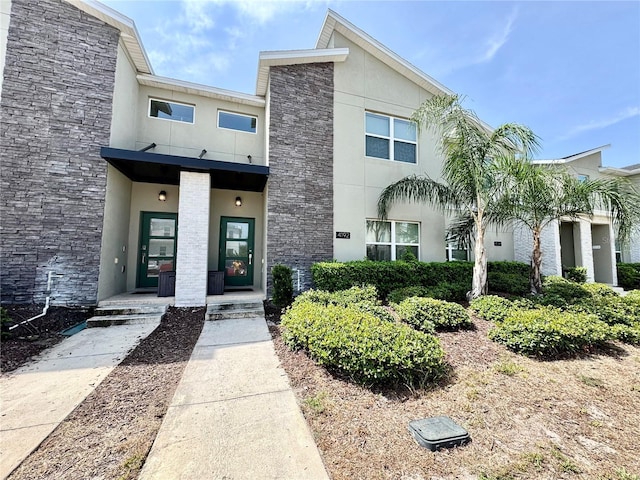 4192 Paragraph Dr, Kissimmee, FL 34746 - view of front facade featuring stucco siding and stone siding