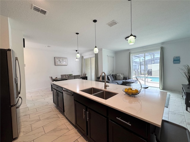 4192 Paragraph Dr, Kissimmee, FL 34746 - kitchen featuring appliances with stainless steel finishes, light marble finish flooring, open floor plan, light countertops, and decorative light fixtures