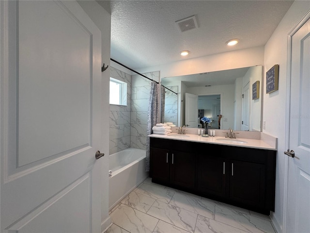 4192 Paragraph Dr, Kissimmee, FL 34746 - full bathroom featuring double vanity, marble finish flooring, shower / tub combo, a textured ceiling, and recessed lighting