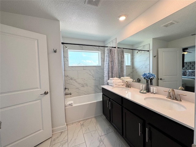 4192 Paragraph Dr, Kissimmee, FL 34746 - bathroom featuring shower / bath combo, double vanity, marble look tiles, and a textured ceiling