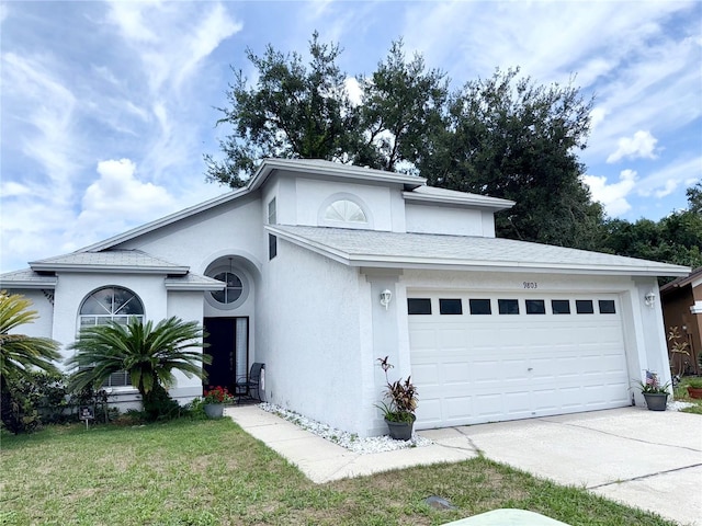 9803 Terrace Trail Ln, Temple Terrace, FL 33637 - view of front of house with stucco siding, a garage, driveway, and a front yard