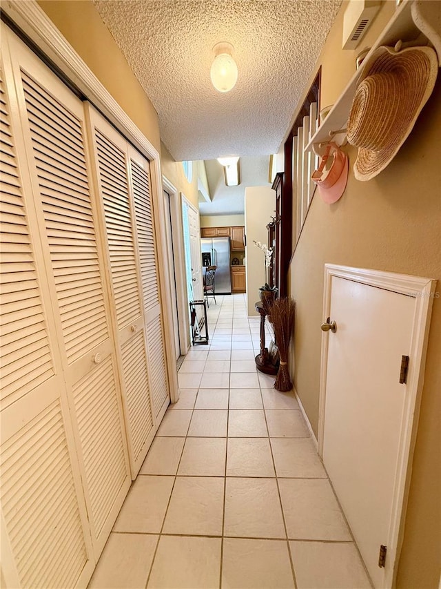9803 Terrace Trail Ln, Temple Terrace, FL 33637 - hall with light tile patterned floors and a textured ceiling