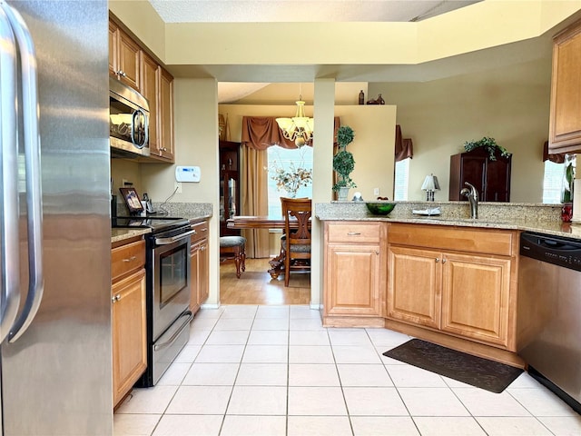 9803 Terrace Trail Ln, Temple Terrace, FL 33637 - kitchen featuring appliances with stainless steel finishes, a chandelier, light tile patterned floors, and light stone countertops