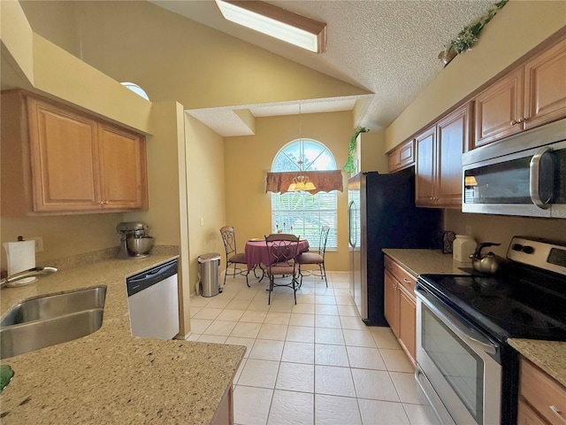9803 Terrace Trail Ln, Temple Terrace, FL 33637 - kitchen with appliances with stainless steel finishes, light tile patterned floors, lofted ceiling, a textured ceiling, and hanging light fixtures