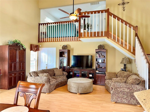 9803 Terrace Trail Ln, Temple Terrace, FL 33637 - living room with a high ceiling, ceiling fan, wood finished floors, and stairway