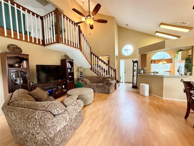 9803 Terrace Trail Ln, Temple Terrace, FL 33637 - living room featuring high vaulted ceiling, wood finished floors, stairs, and a ceiling fan
