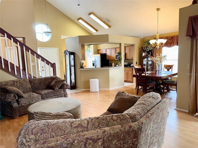 9803 Terrace Trail Ln, Temple Terrace, FL 33637 - living room featuring a chandelier, stairs, light wood finished floors, and a towering ceiling