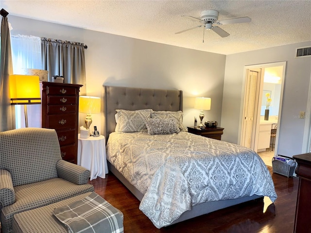 9803 Terrace Trail Ln, Temple Terrace, FL 33637 - bedroom featuring wood finished floors, a textured ceiling, ensuite bathroom, ceiling fan, and a closet