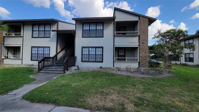 4615 Cason Cove Dr Unit 812, Orlando, FL 32811 - view of front facade featuring a front lawn and stairs