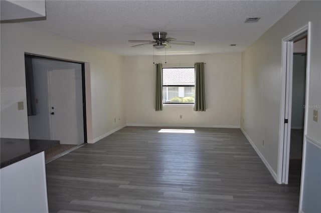 721 Elkhorn Rd, Sun City Center, FL 33573 - spare room with wood finished floors, a ceiling fan, and a textured ceiling