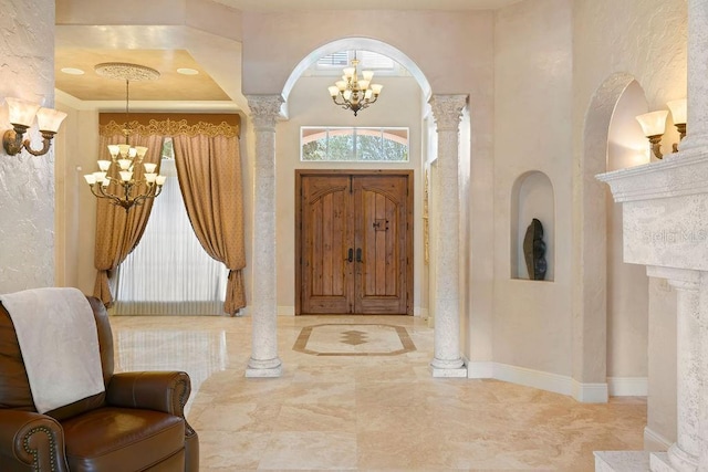 11209 Macaw Ct, Windermere, FL 34786 - foyer featuring a chandelier, decorative columns, and arched walkways
