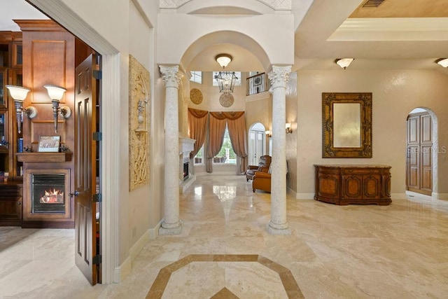 11209 Macaw Ct, Windermere, FL 34786 - corridor featuring ornate columns, marble tiled flooring, and arched walkways