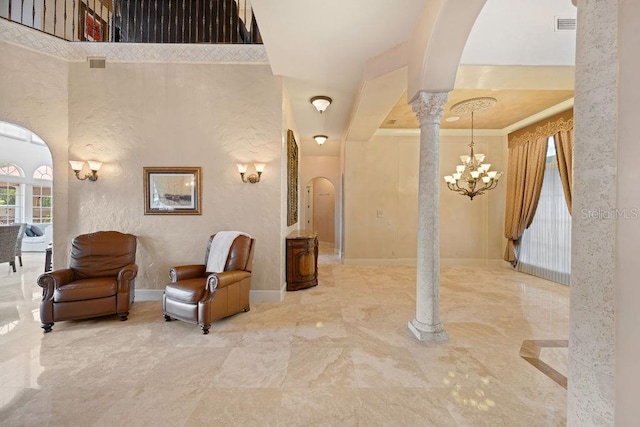 11209 Macaw Ct, Windermere, FL 34786 - interior space featuring arched walkways, a chandelier, marble tiled flooring, ornate columns, and a textured wall