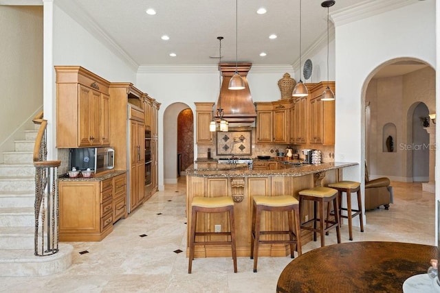 11209 Macaw Ct, Windermere, FL 34786 - kitchen with arched walkways, a peninsula, dark stone counters, recessed lighting, and decorative backsplash