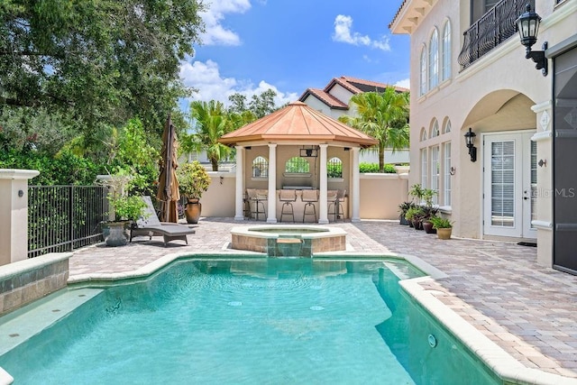 11209 Macaw Ct, Windermere, FL 34786 - view of pool featuring french doors, a patio area, and a pool with connected hot tub