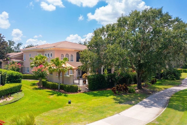 11209 Macaw Ct, Windermere, FL 34786 - mediterranean / spanish home with a tiled roof, a front yard, and stucco siding