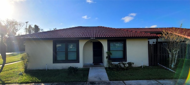563 Hunter Cir, Kissimmee, FL 34758 - view of front of house with stucco siding and a tiled roof