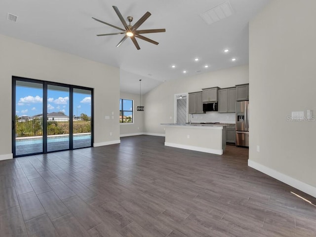 10381 Rainsville St, Port Charlotte, FL 33981 - unfurnished living room with ceiling fan, recessed lighting, dark wood-style flooring, and vaulted ceiling
