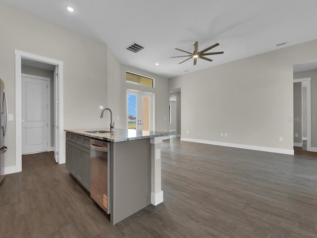 10381 Rainsville St, Port Charlotte, FL 33981 - kitchen featuring open floor plan, a ceiling fan, appliances with stainless steel finishes, a kitchen island with sink, and dark wood-type flooring