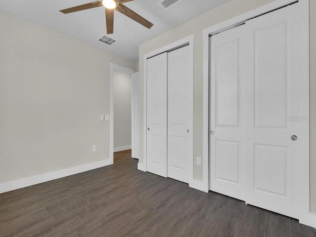 10381 Rainsville St, Port Charlotte, FL 33981 - unfurnished bedroom featuring dark wood-style floors, a ceiling fan, and multiple closets