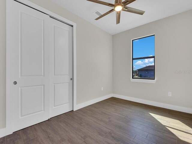 10381 Rainsville St, Port Charlotte, FL 33981 - unfurnished bedroom with wood finished floors, a closet, and a ceiling fan